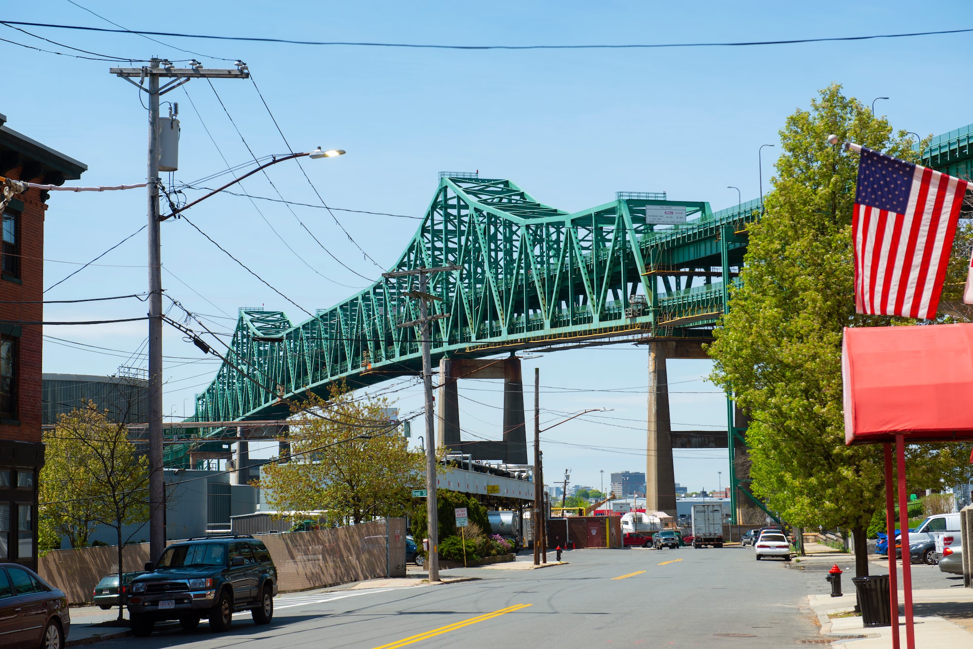 Metal, green Maurice Tobin Bridge with street below and cars.